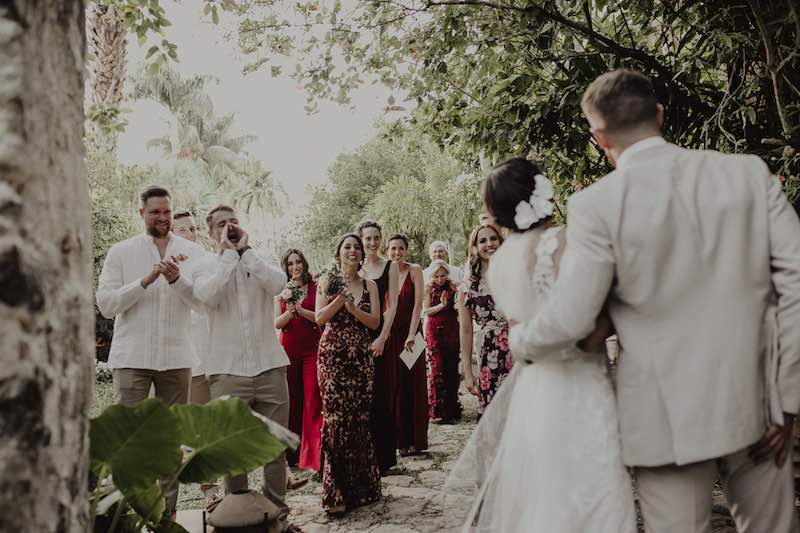 happy wedding guests, bride and groom at destination wedding in yucatan