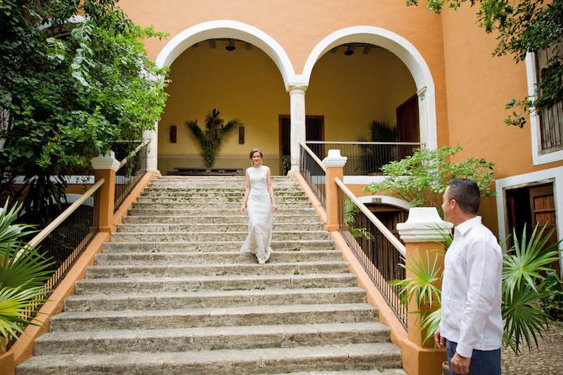 Happy bride down the stairs from Hacienda Itzincab